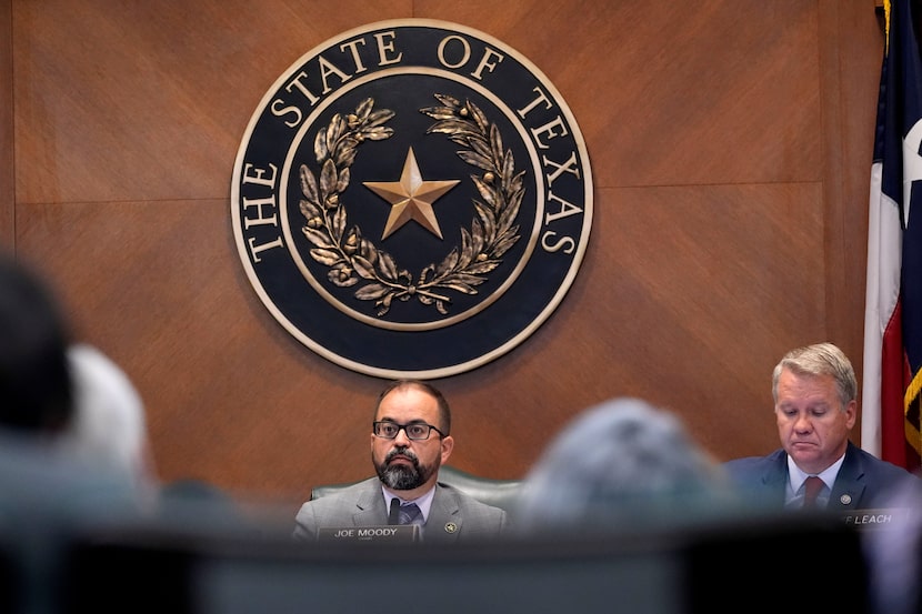 Texas Rep. Joe Moody, D-El Paso, center, and Rep. David Cook, R-Mansfield, right, listen to...