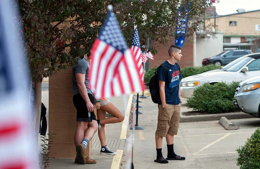 Joshua Reid, right, an 18-year-old Stephen F. Austin State University history student, waits...