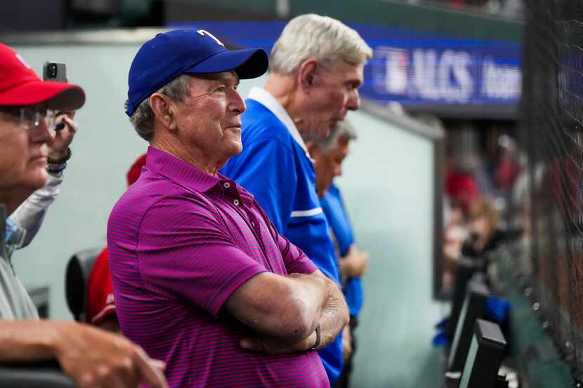 Former President George W. Bush watches as the benches clear during the eighth inning in...