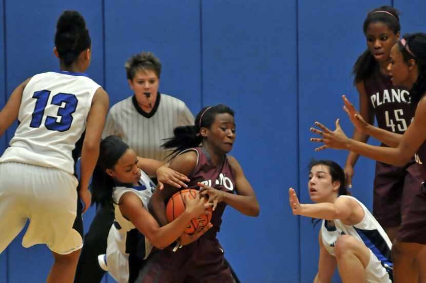 Plano West junior Kaelin Montgomery (23) and Plano sophomore Kara Mitchell (5) battle for a...