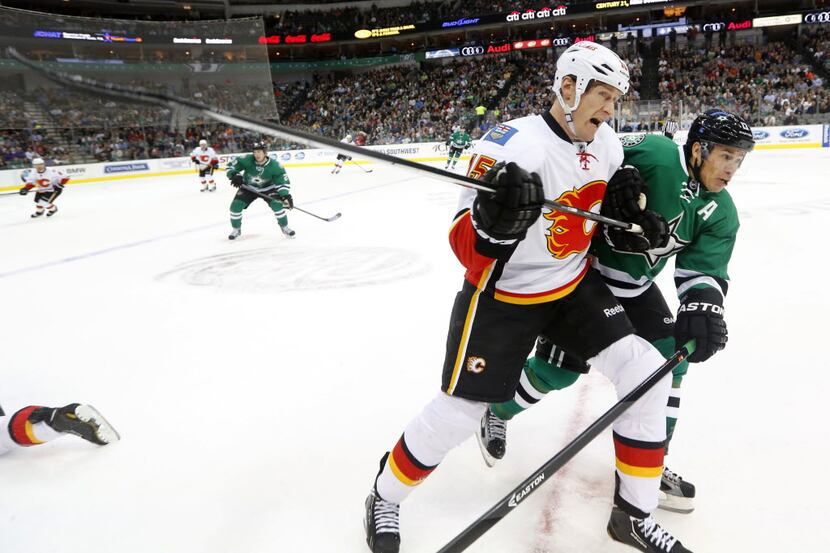 Calgary Flames right wing Tim Jackman (15) and Dallas Stars left wing Ray Whitney (13) check...