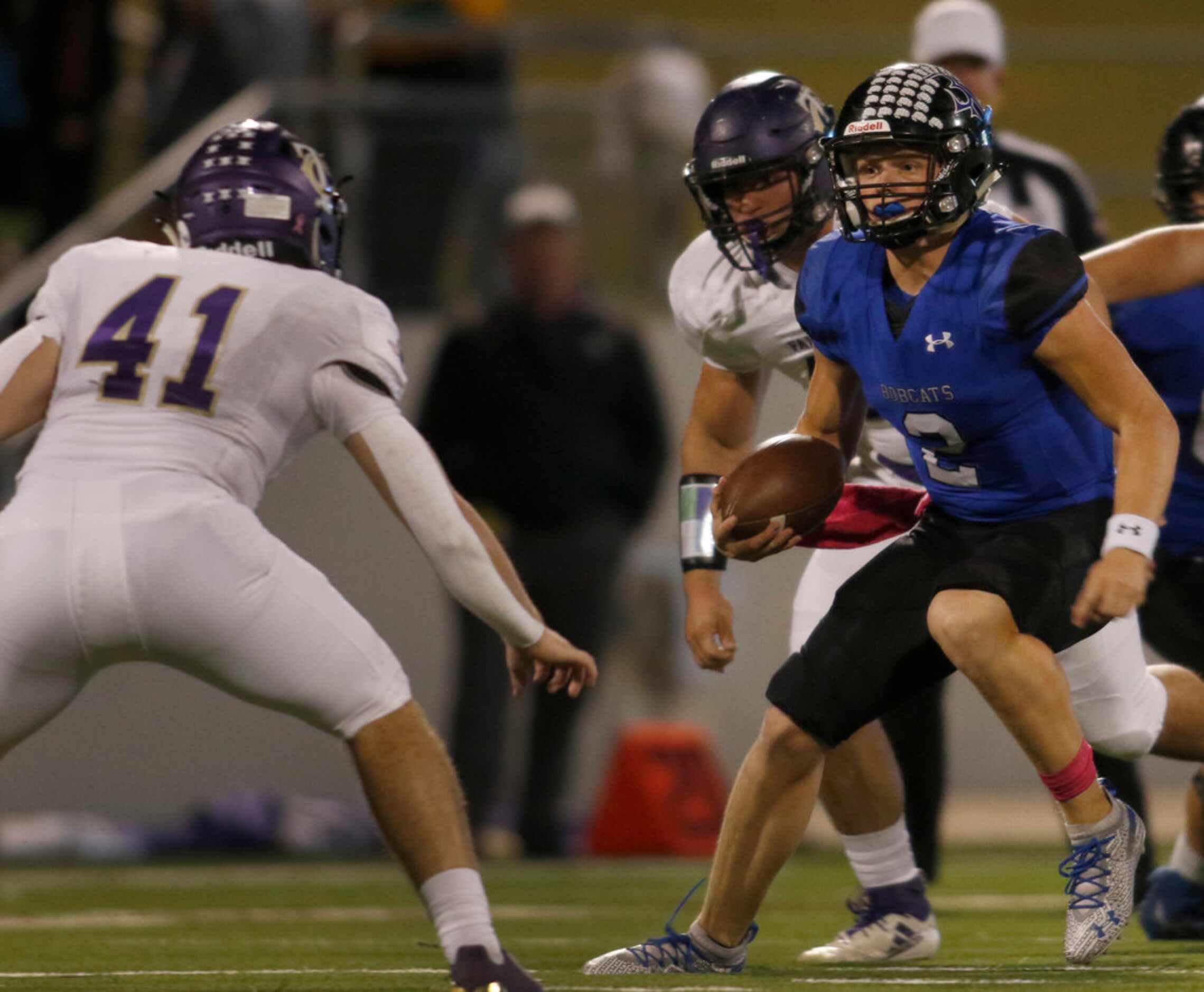 Trophy Club Byron Nelson quarterback Hudson White (2) eyes the defense of Keller Timber...