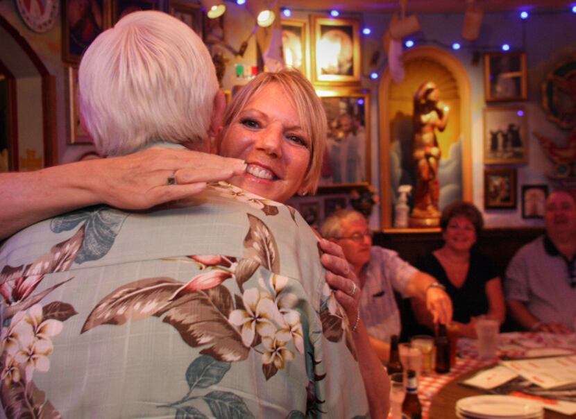 Pam Wood and Tracy Cross hug as they and other members of a Parkinson's disease online...