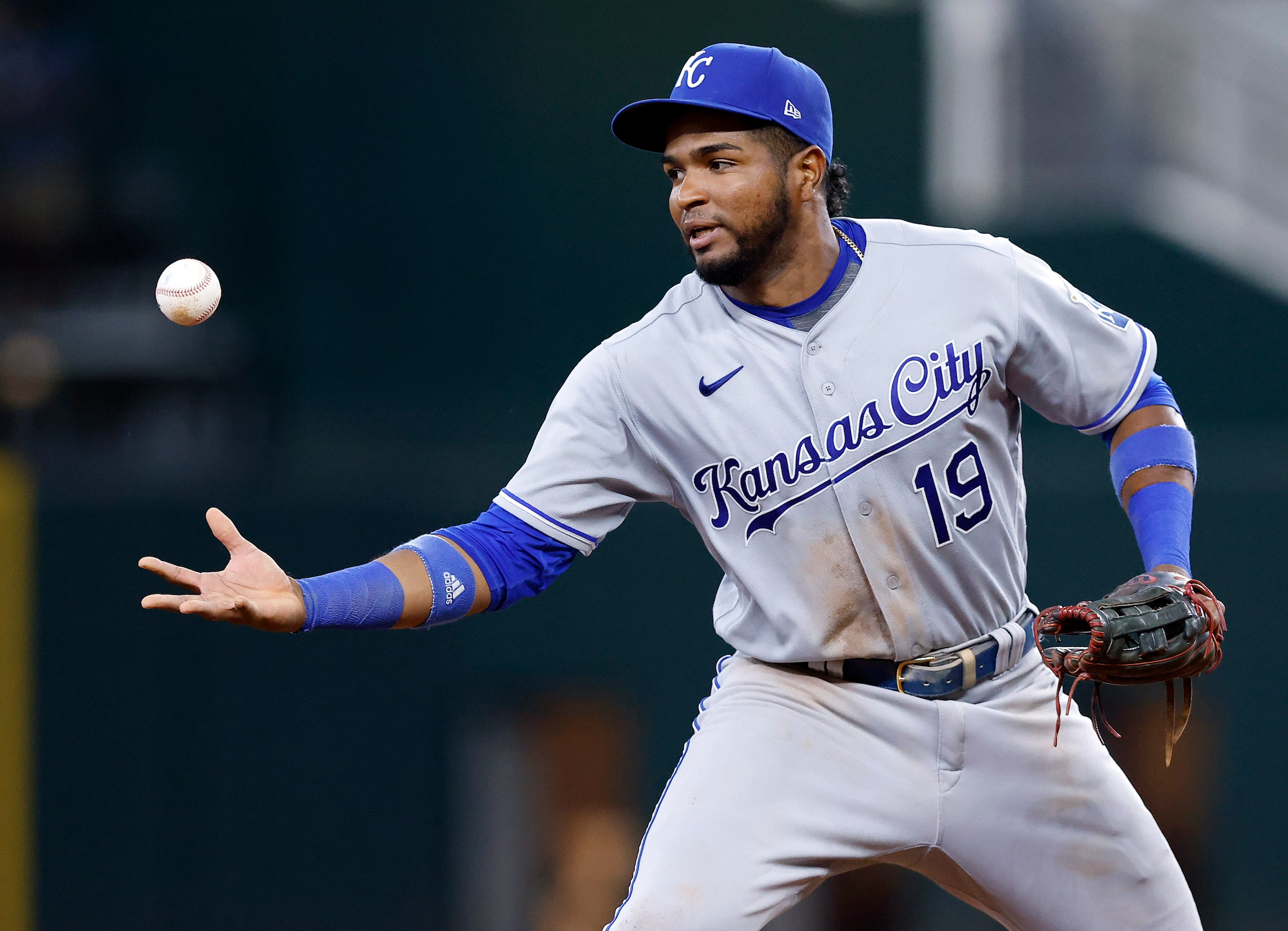 Kansas City Royals third baseman Kelvin Gutierrez (19) can't find the handle on an infield...