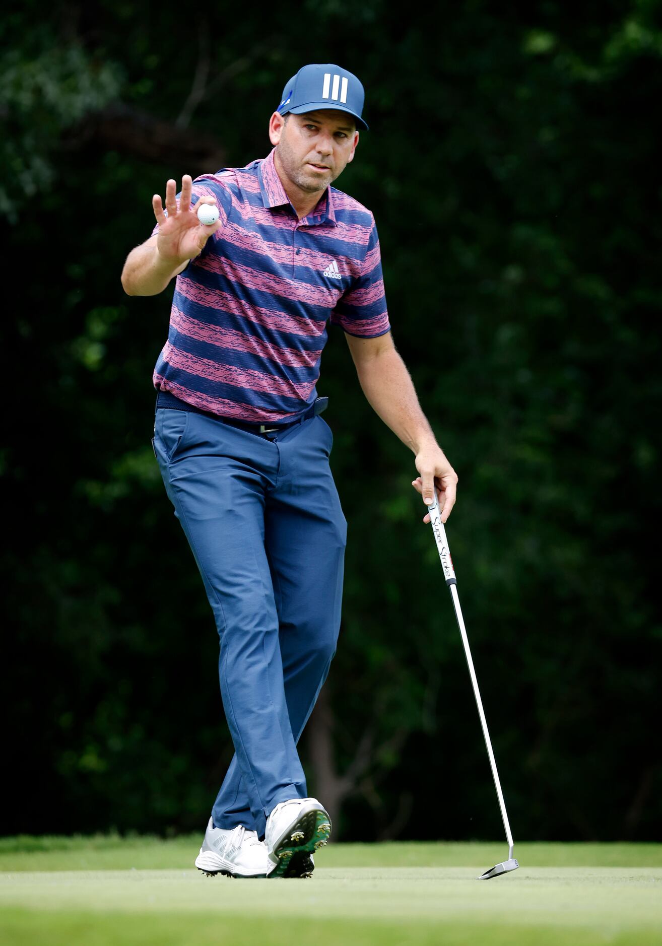 Professional golfer Sergio Garcia acknowledges the applause after putting on No. 5 during...