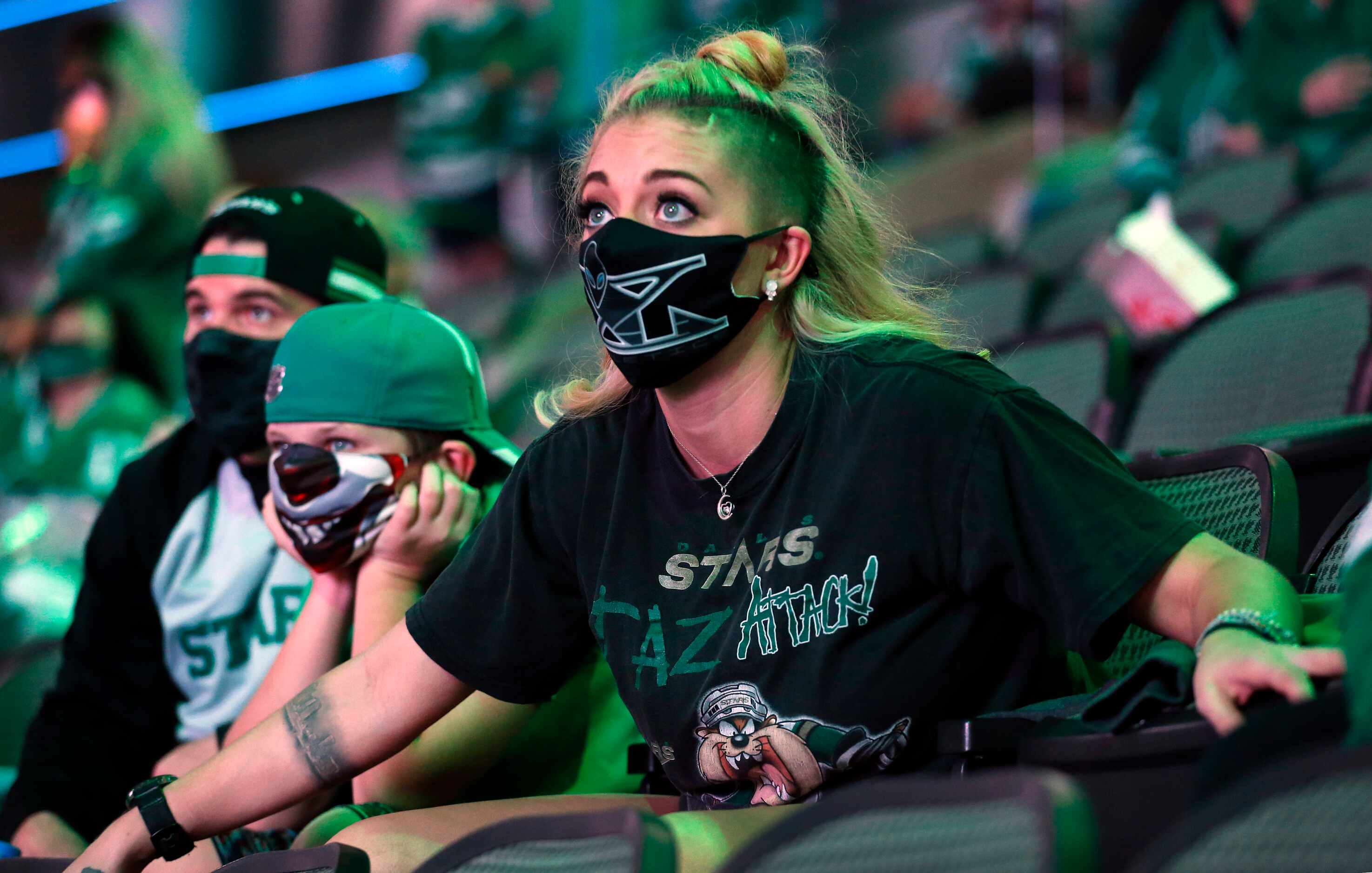 Dallas Stars fans Caty McColpin of Fort Worth is on the edge of her seat in overtime as she...