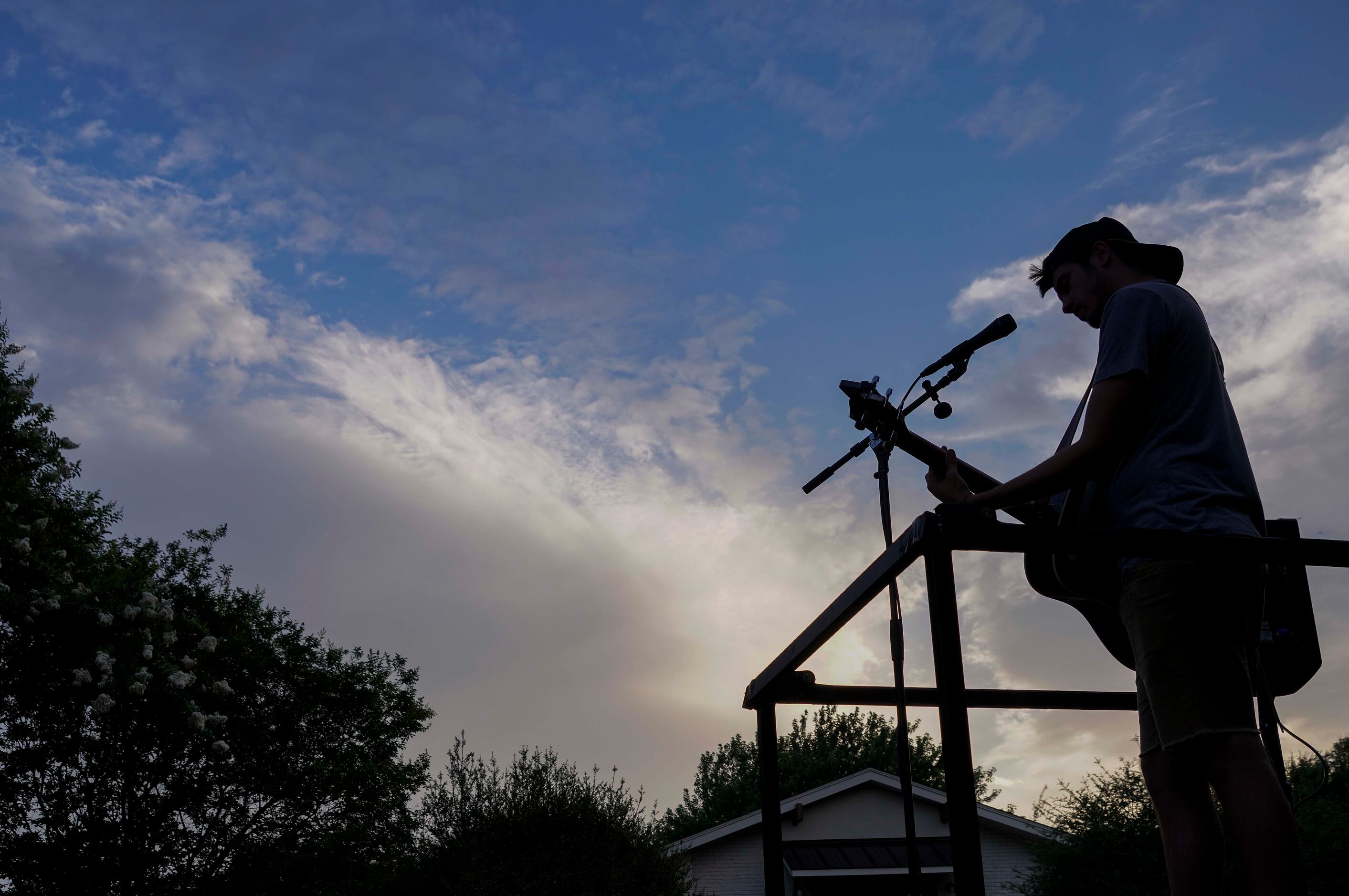Cameron Havens sings from the back of a pickup truck during a 'Drive By Concert'  through...