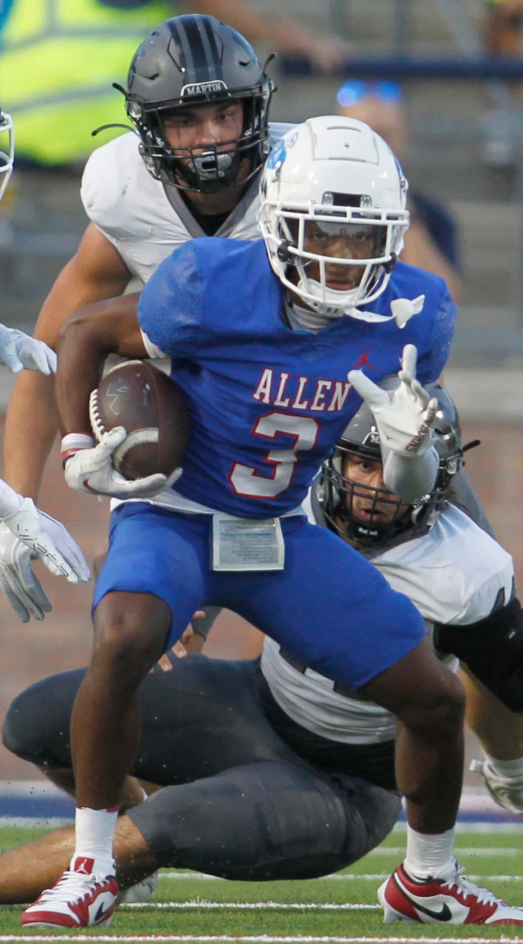 Allen receiver Caleb Smith (3) looks for running room as he is pursued by Arlington Martin...