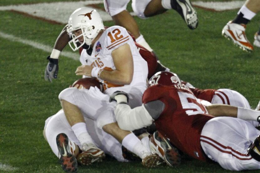 ORG XMIT: BCS1 Texas quarterback Colt McCoy (12) is tackled by Alabama defenders during the...