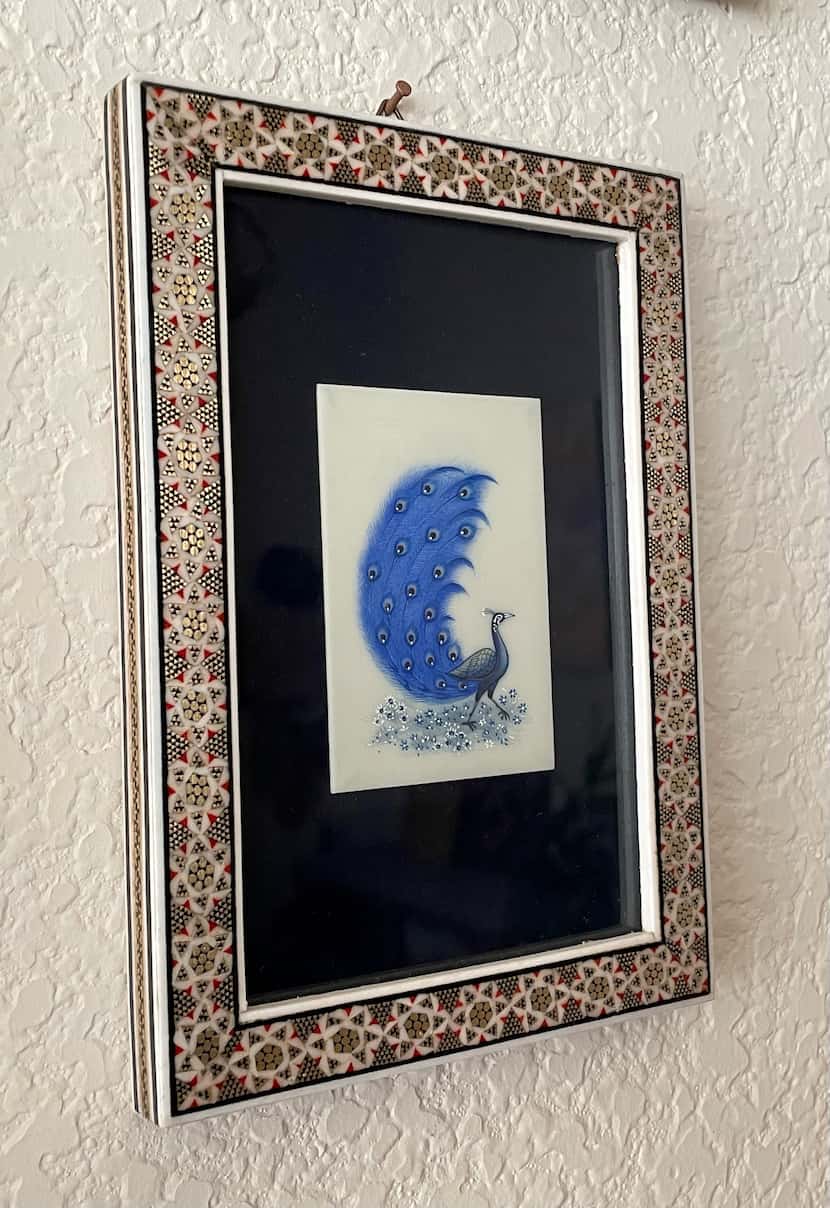 The Persian miniature painting of a peacock was created by artist Mostafa Fotovat.