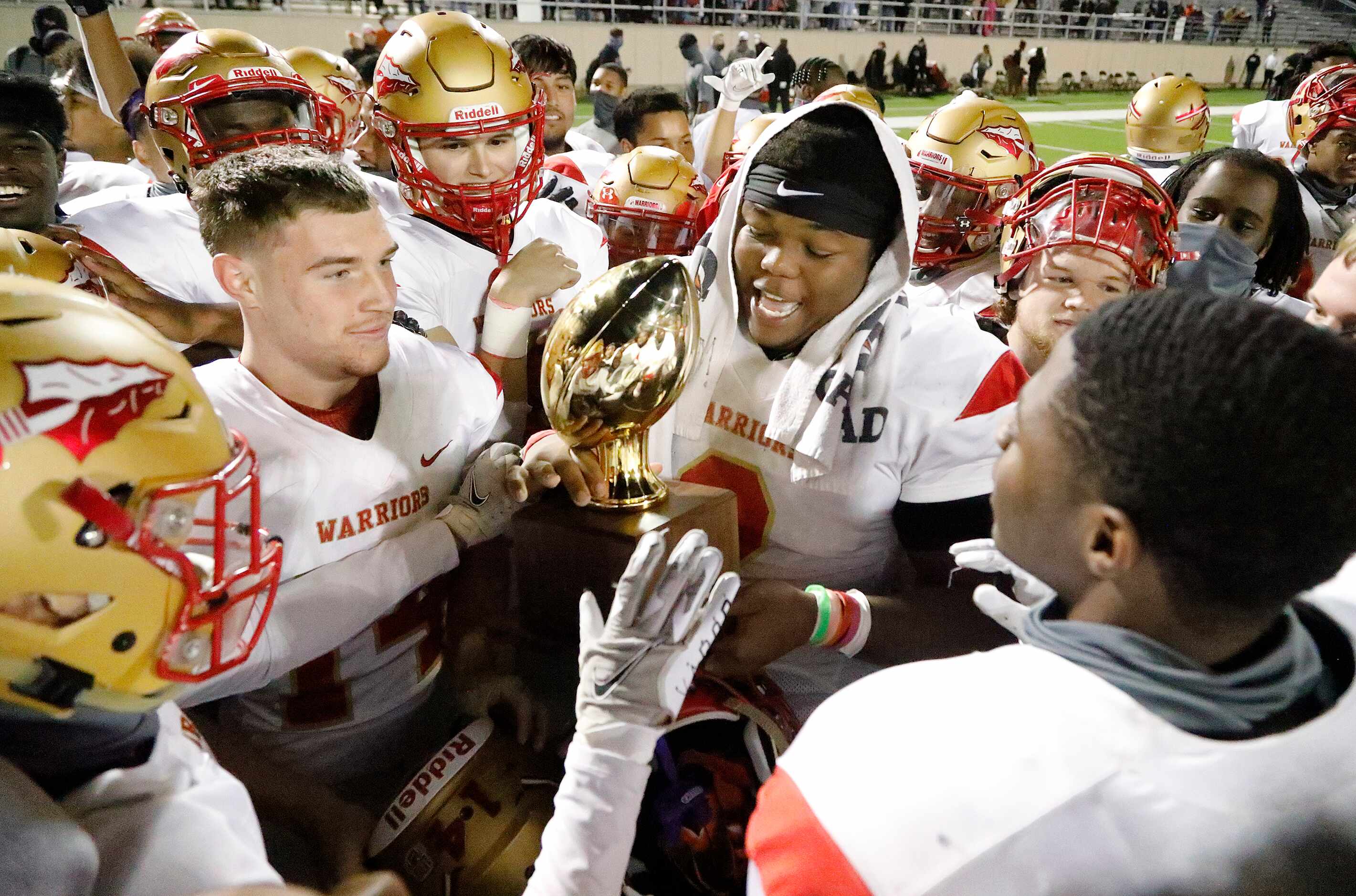South Grand Prairie High School middle linebacker Marsel McDuffie (2) holds the trophy as...