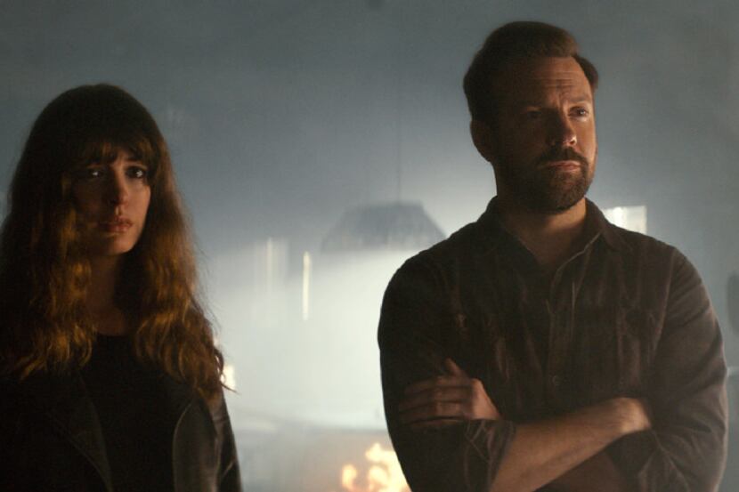 In this image released by Neon, Jason Sudeikis (right) and Anne Hathaway appear in a scene...