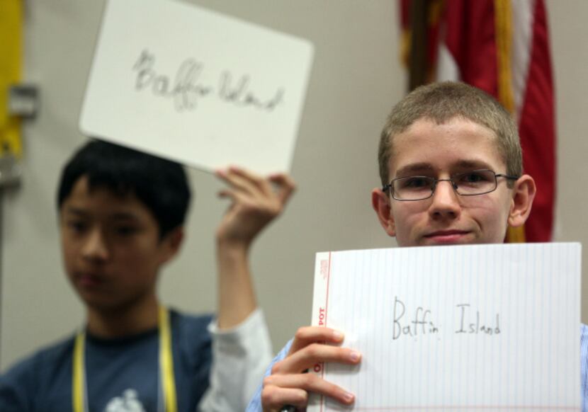 Luka Valencic (right) of Colleyville Middle School holds up his answer during one of the...