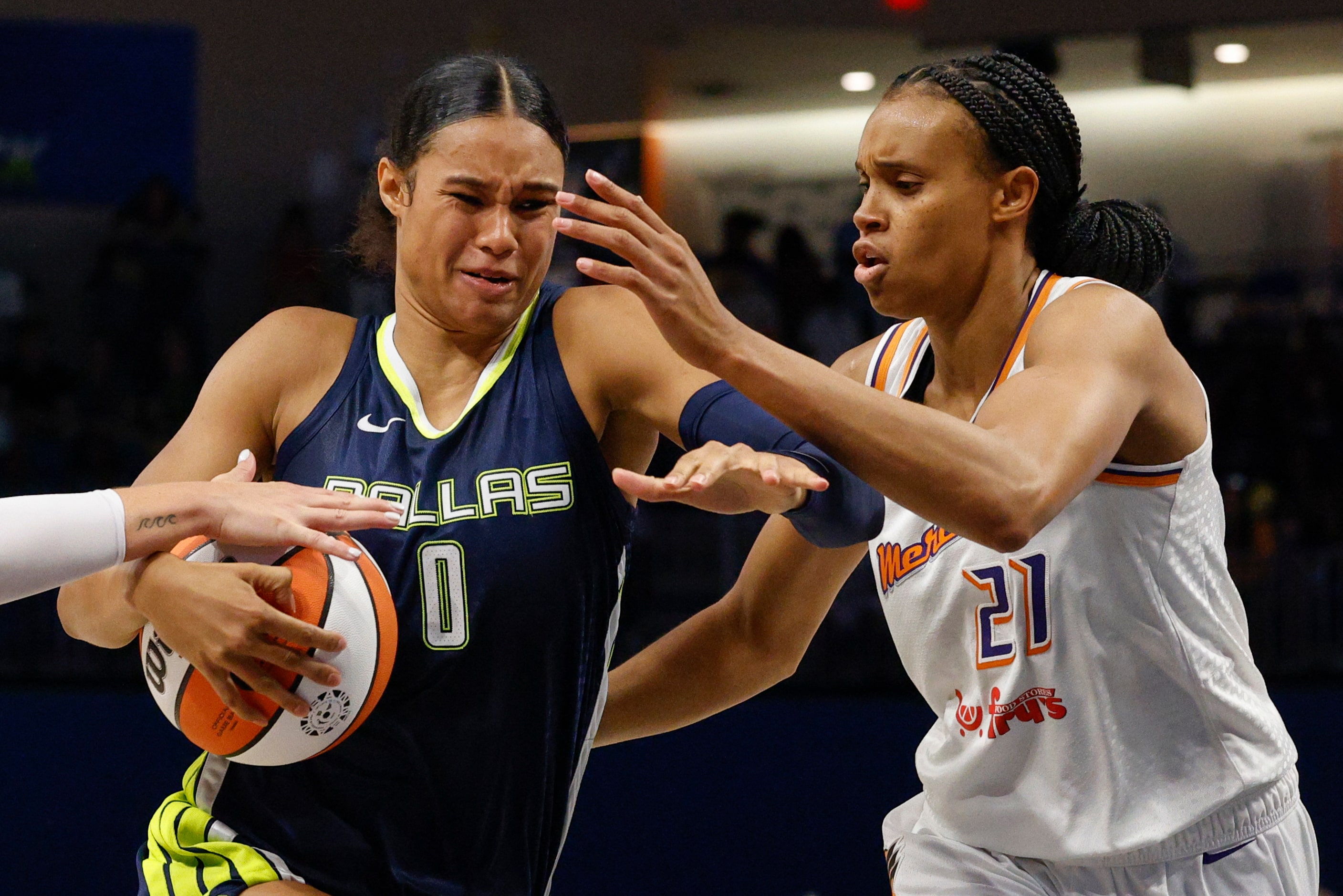 Dallas Wings forward Satou Sabally (0) drives to the basket alongside Phoenix Mercury...