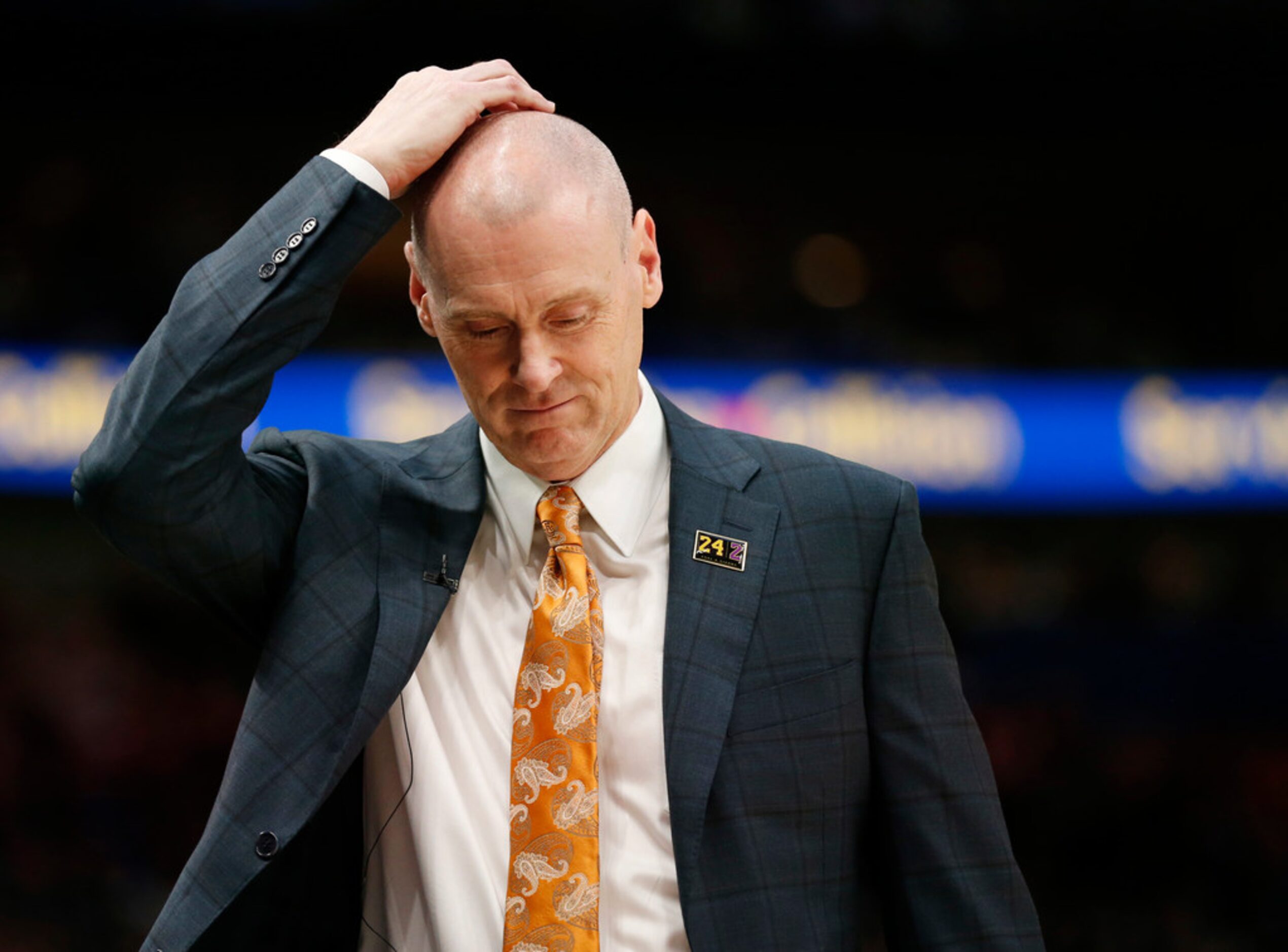 Dallas Mavericks head coach Rick Carlisle rubs his head as he walks towards the bench during...