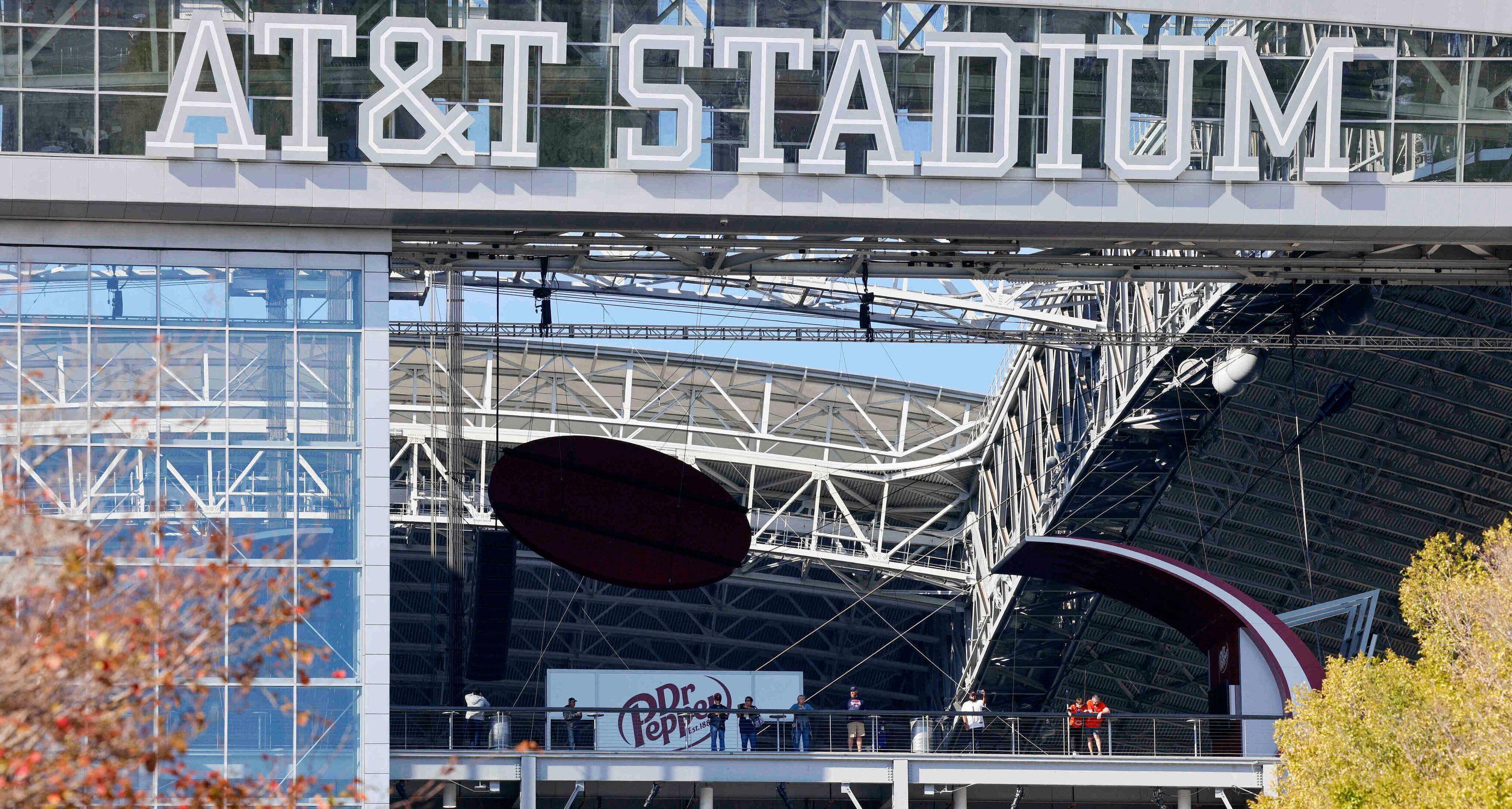 People stand along the upper concourse with the roof and end zone doors open before an NFL...