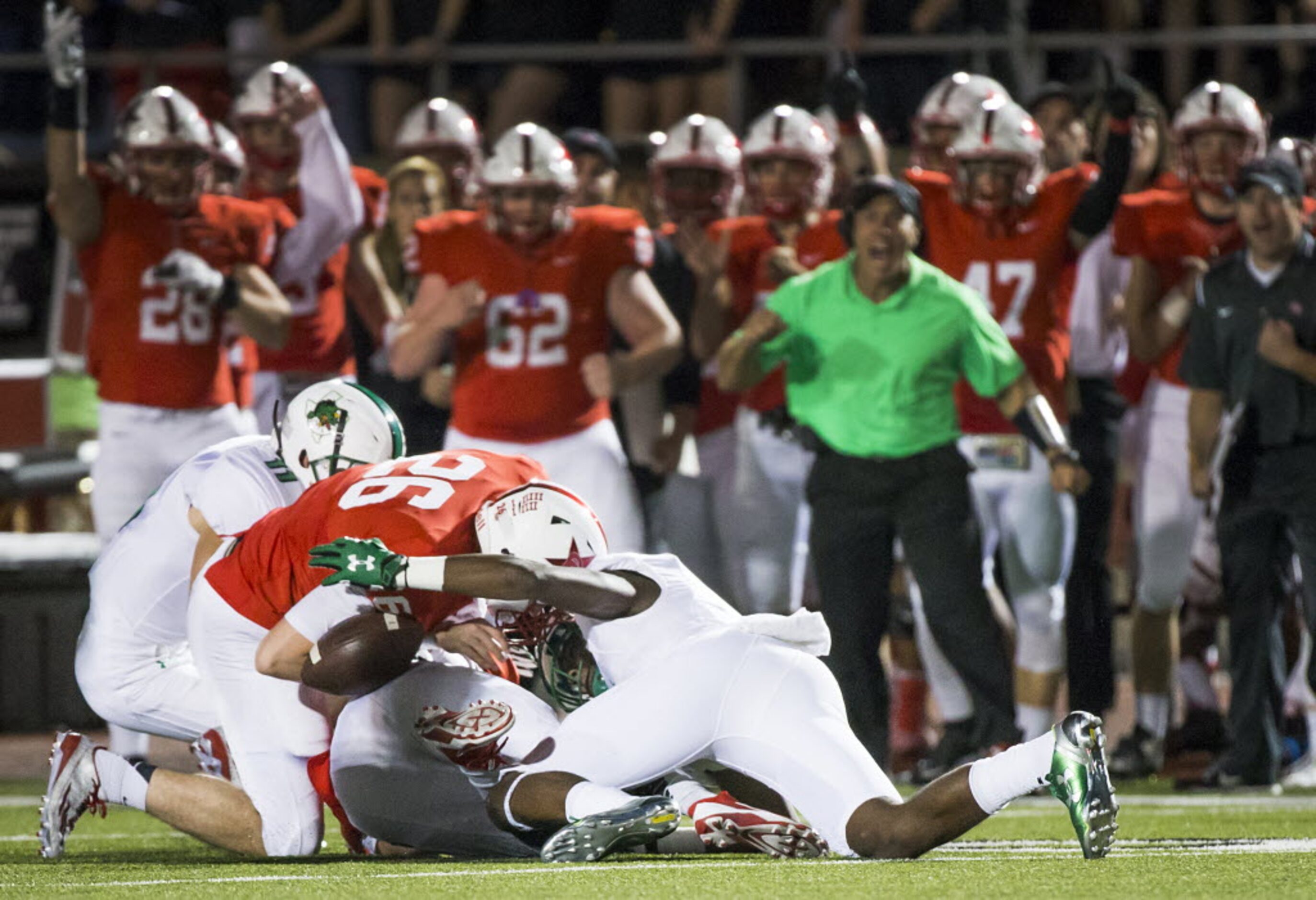 Coppell's Drew Smith (26) reaches for a fumble by Southlake Carroll's Lil' Jordan Humphrey...