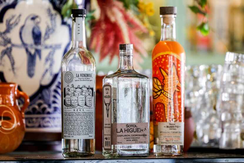 Bottles of raicilla "La Venenosa" (from left), sotol "La Higuera" and mezcal "Burrito" are...