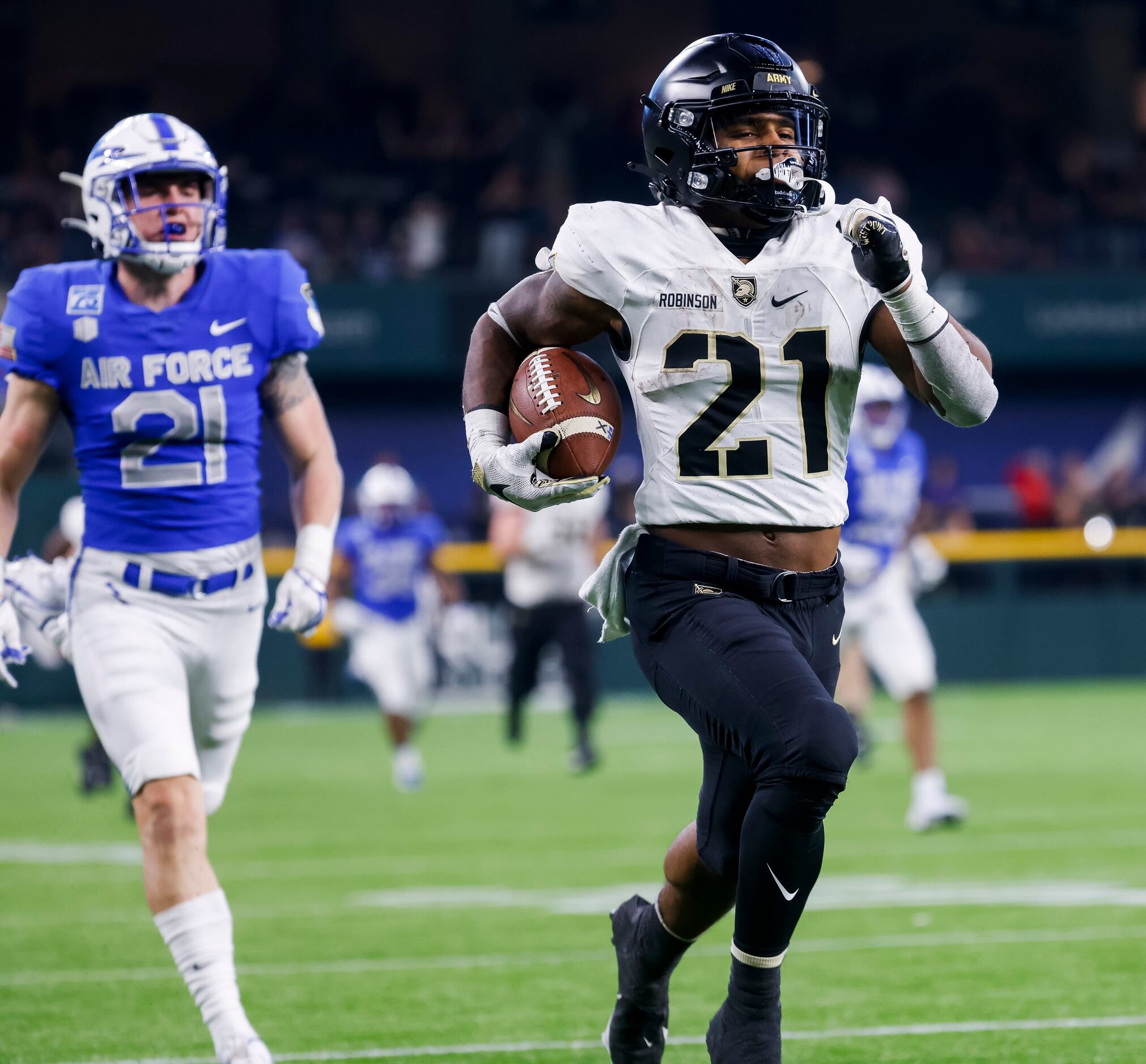Army Black Knights running back Tyrell Robinson (21) outruns Air Force Falcons safety Corvan...
