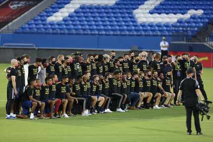 FC Dallas players took the field to thank fans and pose for a photo after the suspension of...