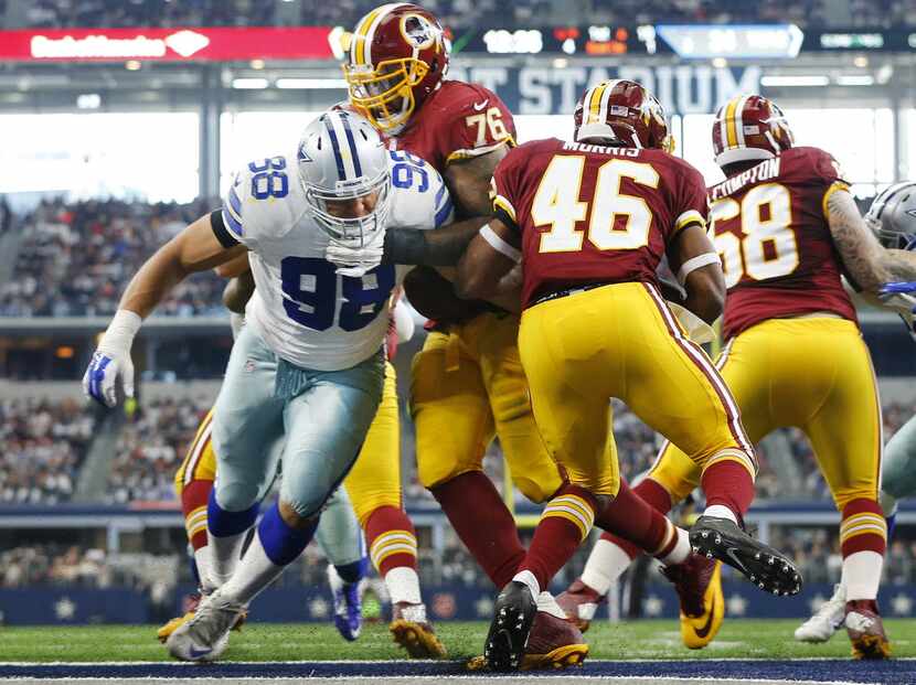 Dallas Cowboys defensive tackle Tyrone Crawford (98) tries to stop Washington Redskins...