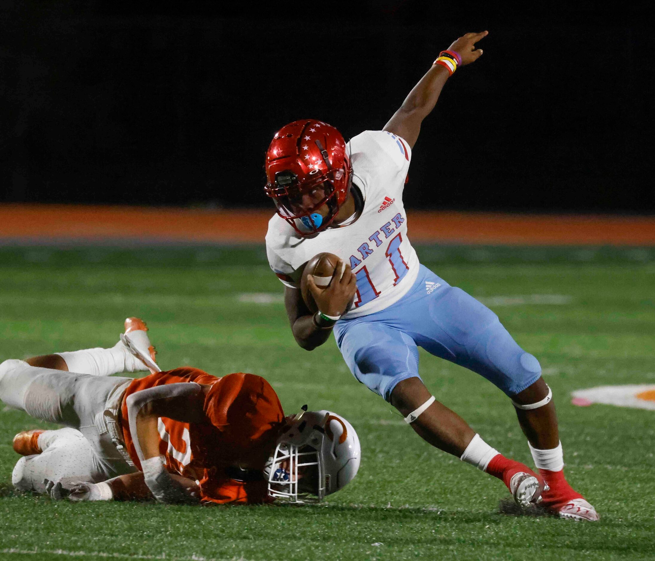 David W. Carter High School’s Camden Patterson (11), right, runs past Celina High School’s...