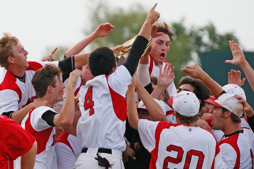 Mansfield Legacy catcher Corey Murray, center facing camera, celebrates with teammates after...