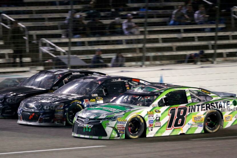 Kyle Busch (18), Brian Vickers (14) and Reed Sorenson (55) race during Duck Commander 500 at...