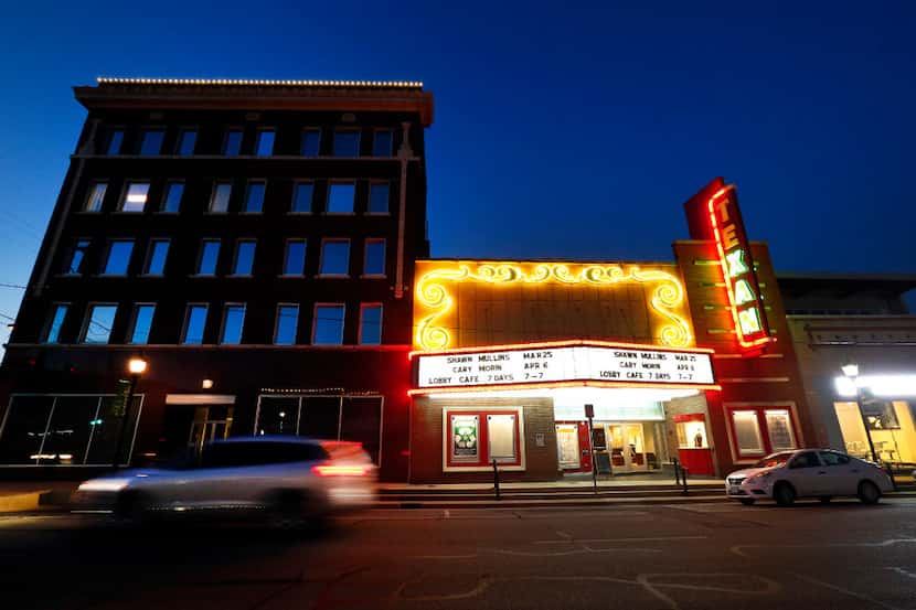 The neon lights are aglow as the sun sets over the Texan Theater in downtown Greenville,...