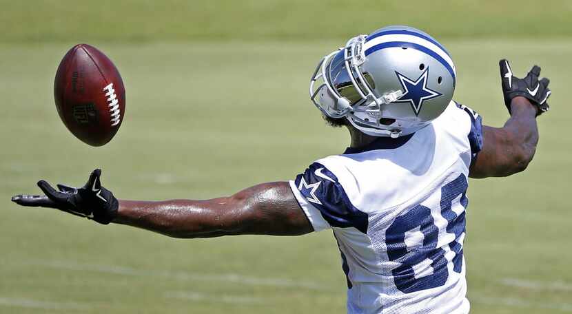 Dallas Cowboys wide receiver Dez Bryant juggles the ball during a minicamp at Valley Ranch...
