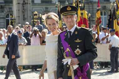 King Philippe of Belgium and his wife, Queen Mathilde, walk through Brussels on July 21,...