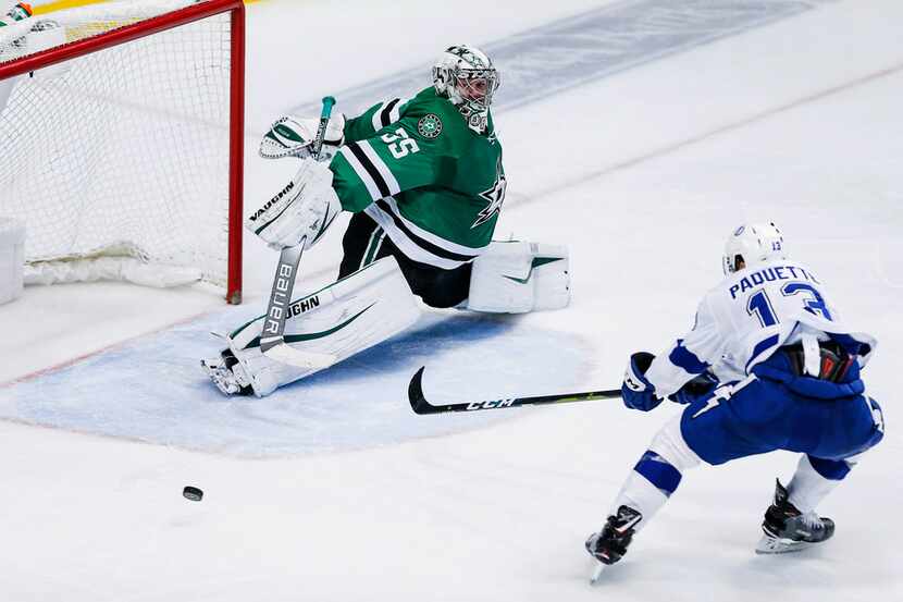 Tampa Bay Lightning forward Cedric Paquette (13) is unable to reach a pass as Dallas Stars...