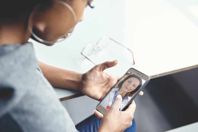 Woman having a virtual conference with doctor on a cellphone