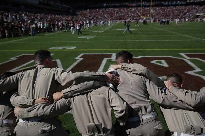Members of the Texas A&M Corps of Cadets on the field before an NCAA football game between...