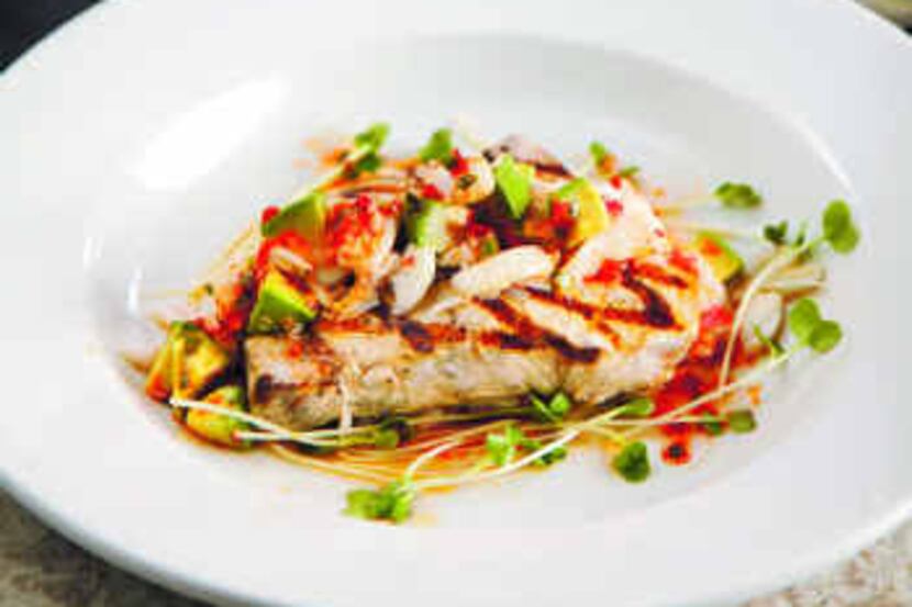  Spoon a slightly spicy vinaigrette, avocado, lump crab and sprouts over grilled swordfish...