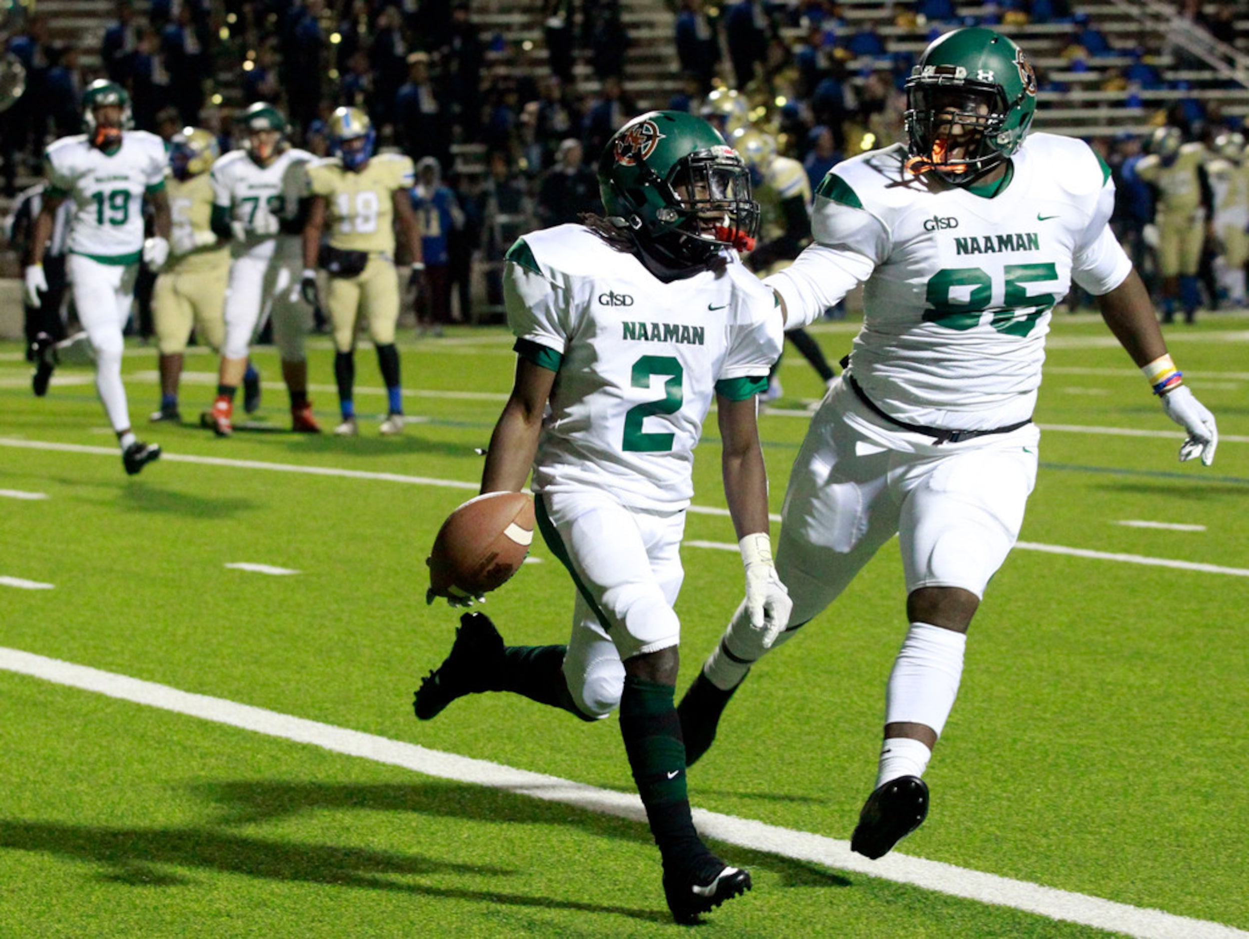 Naaman Forest Kingsley Bennett (2) celebrates with teammate Jau'qwez Jones (85), after...