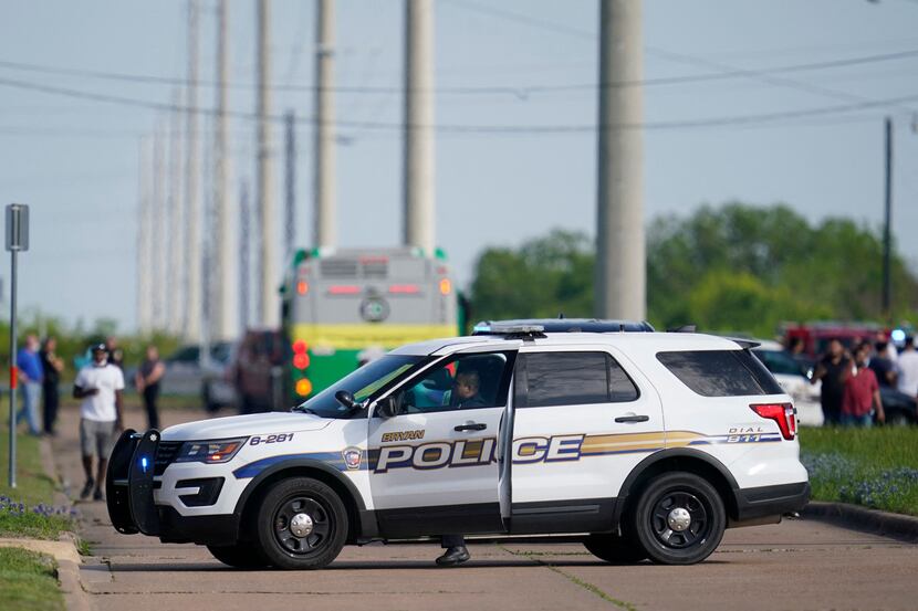 A Bryan police officer blocks road access near the scene of a mass shooting at an industrial...