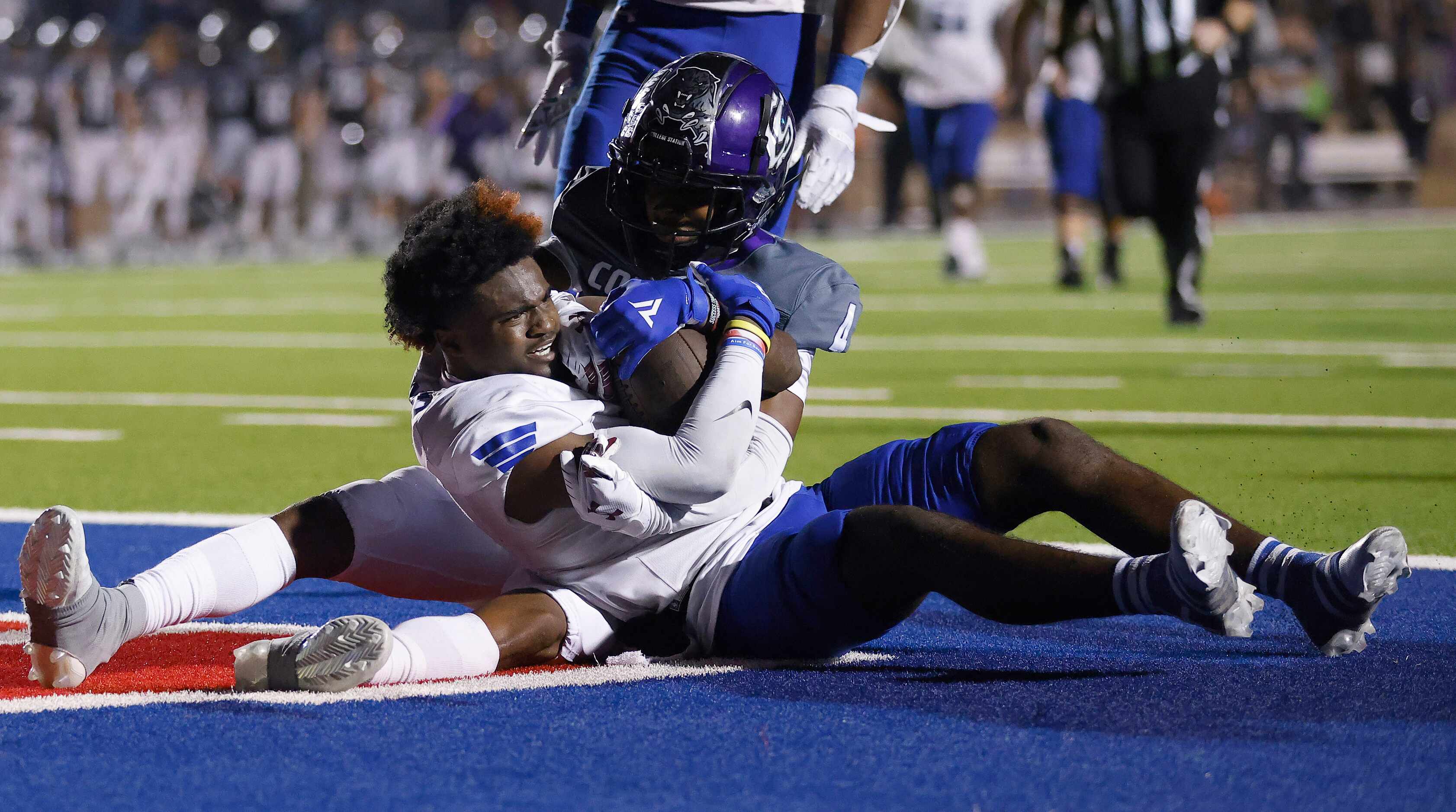 Mansfield Summit wide receiver Kerya Powell (2) wrestles with College Station defensive back...