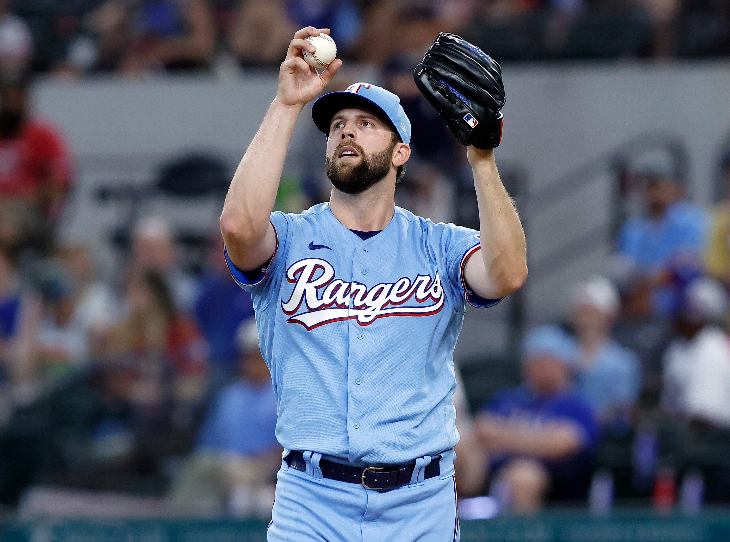 Texas Rangers starting pitcher Jordan Lyles (24) takes a moment before pitching to the...