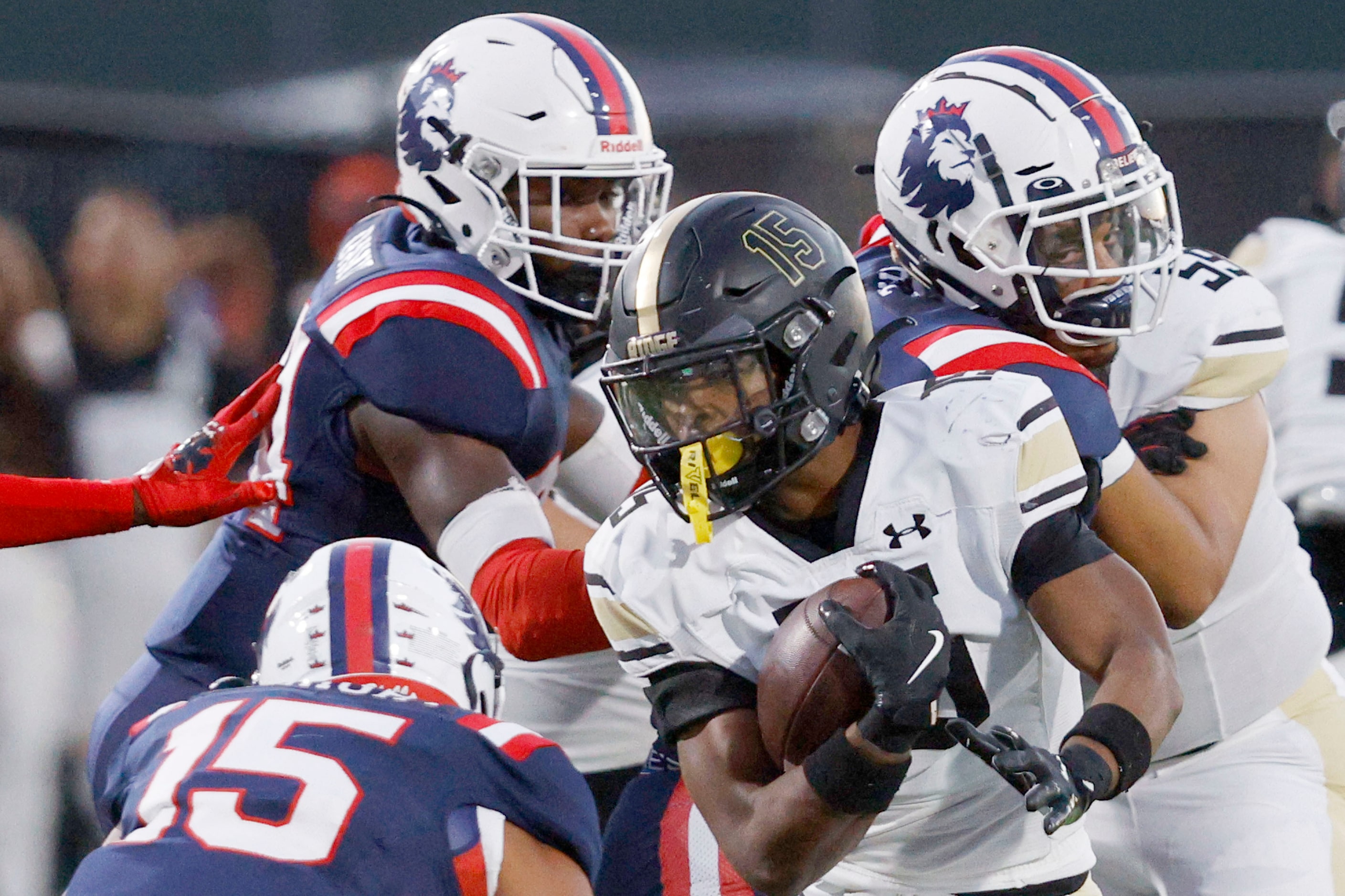 Fossil Ridge's Draylon Galloway (15) is tackled by Richland's Sean Wright (15), Richland's...