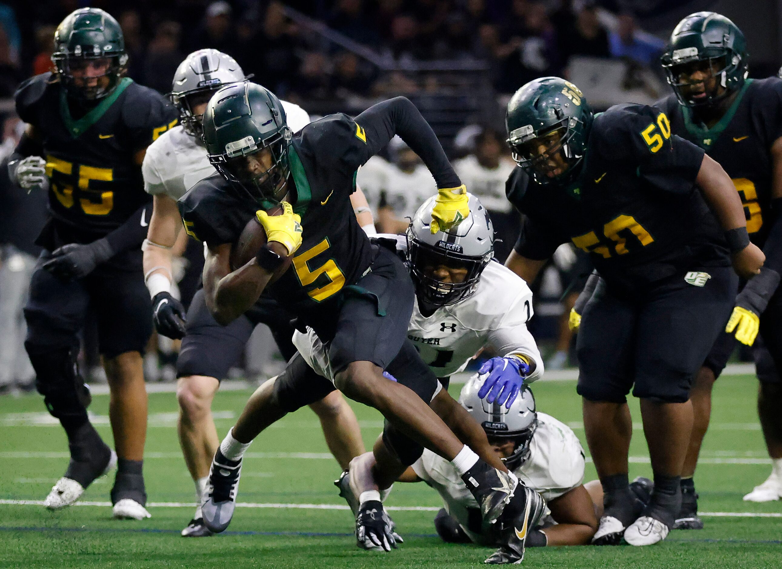 DeSoto running back Tre Wisner (5) breaks a tackle on a fourth quarter run against Denton...