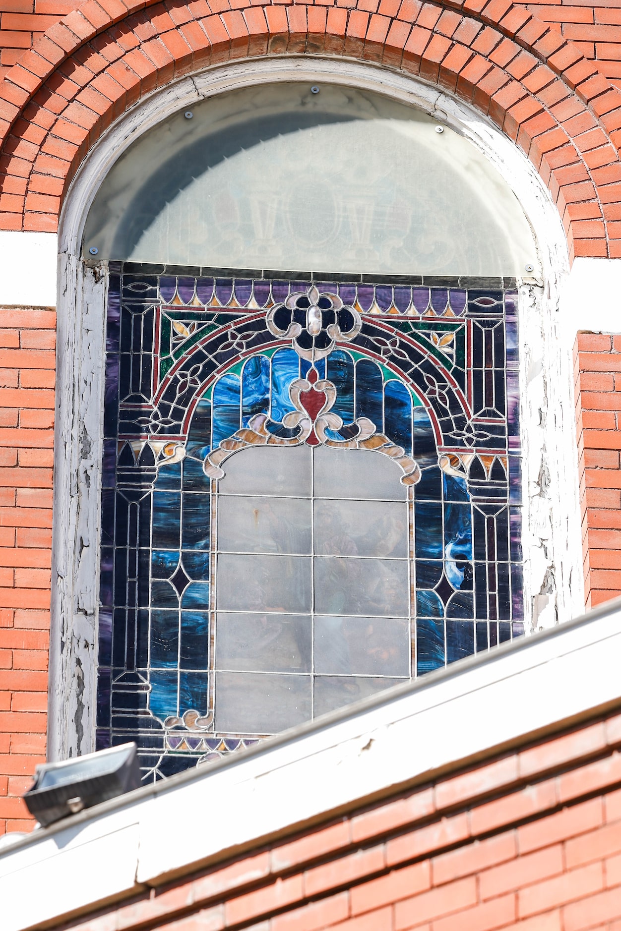 One of the upper-most stained-glass windows at St. Joseph’s Catholic Church in Old East Dallas.