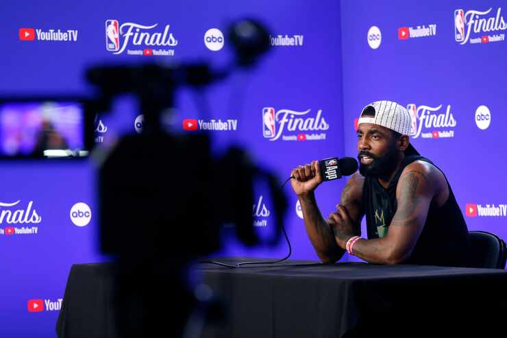 Dallas Mavericks player Kyrie Irving answers questions from the media during a NBA Finals...
