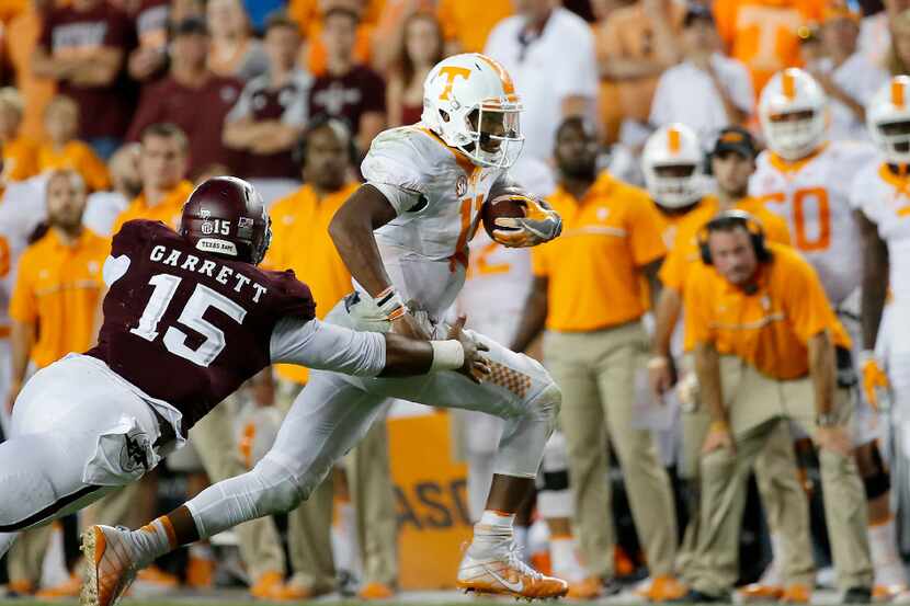 Tennessee quarterback Joshua Dobbs (11) is tackled by Texas A&M defensive lineman Myles...