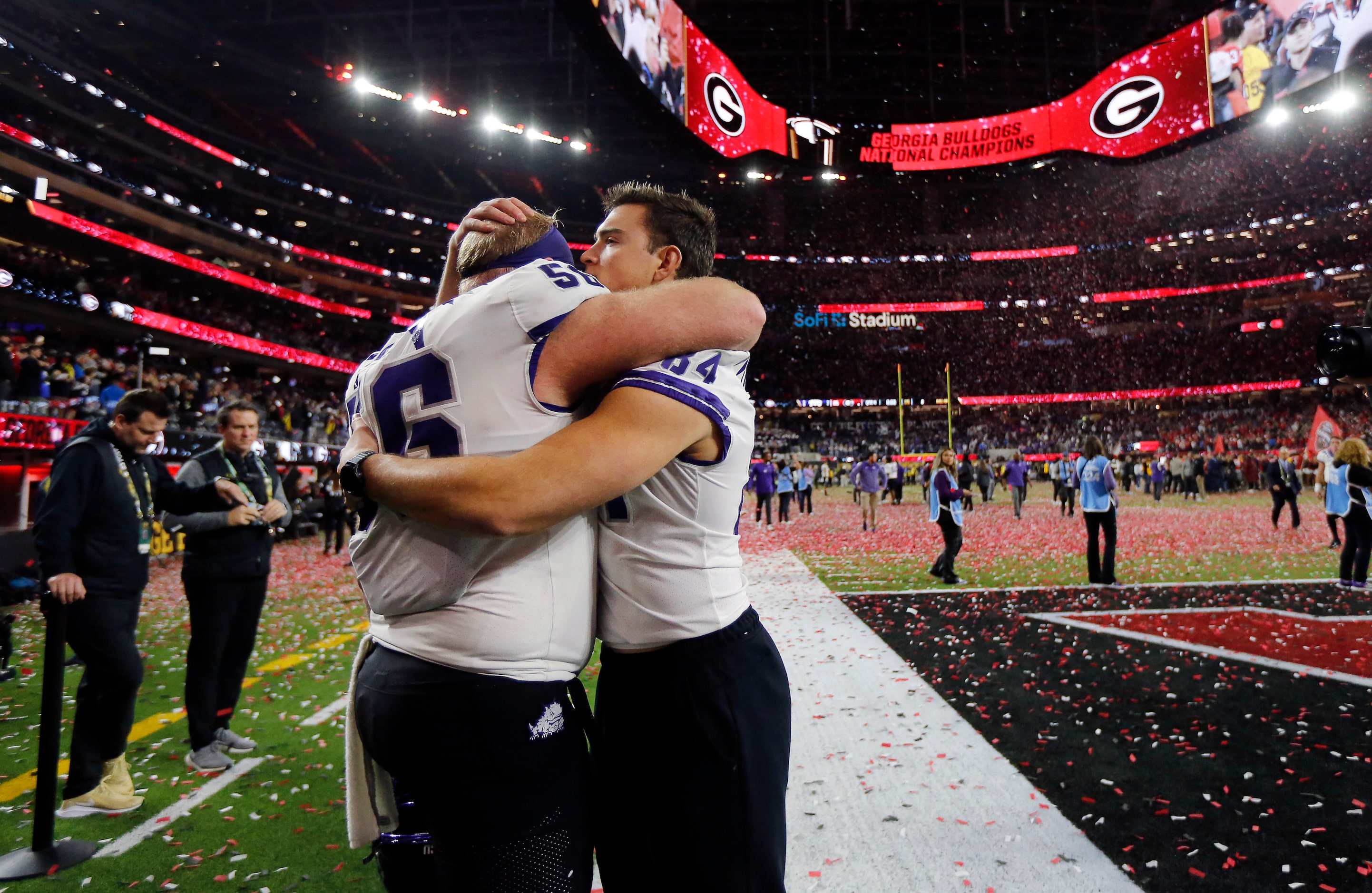 TCU Horned Frogs offensive lineman Alan Ali (56) gives tight end Dominic DiNunzio (84) a hug...