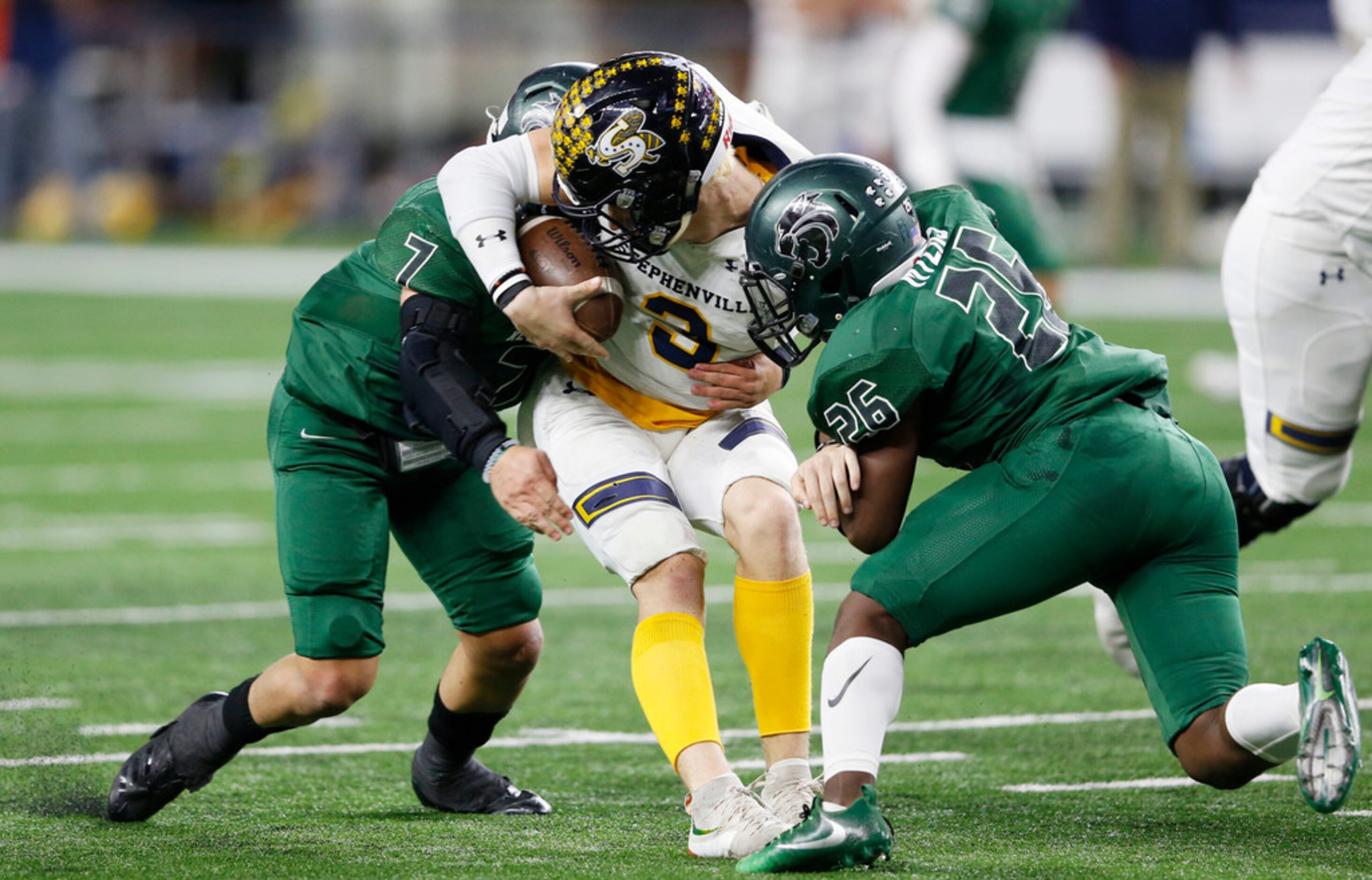 Kennedale's Ector Rivera (7) and Jalen Myers (26) sack Stephenville's Easton Jones (3)...