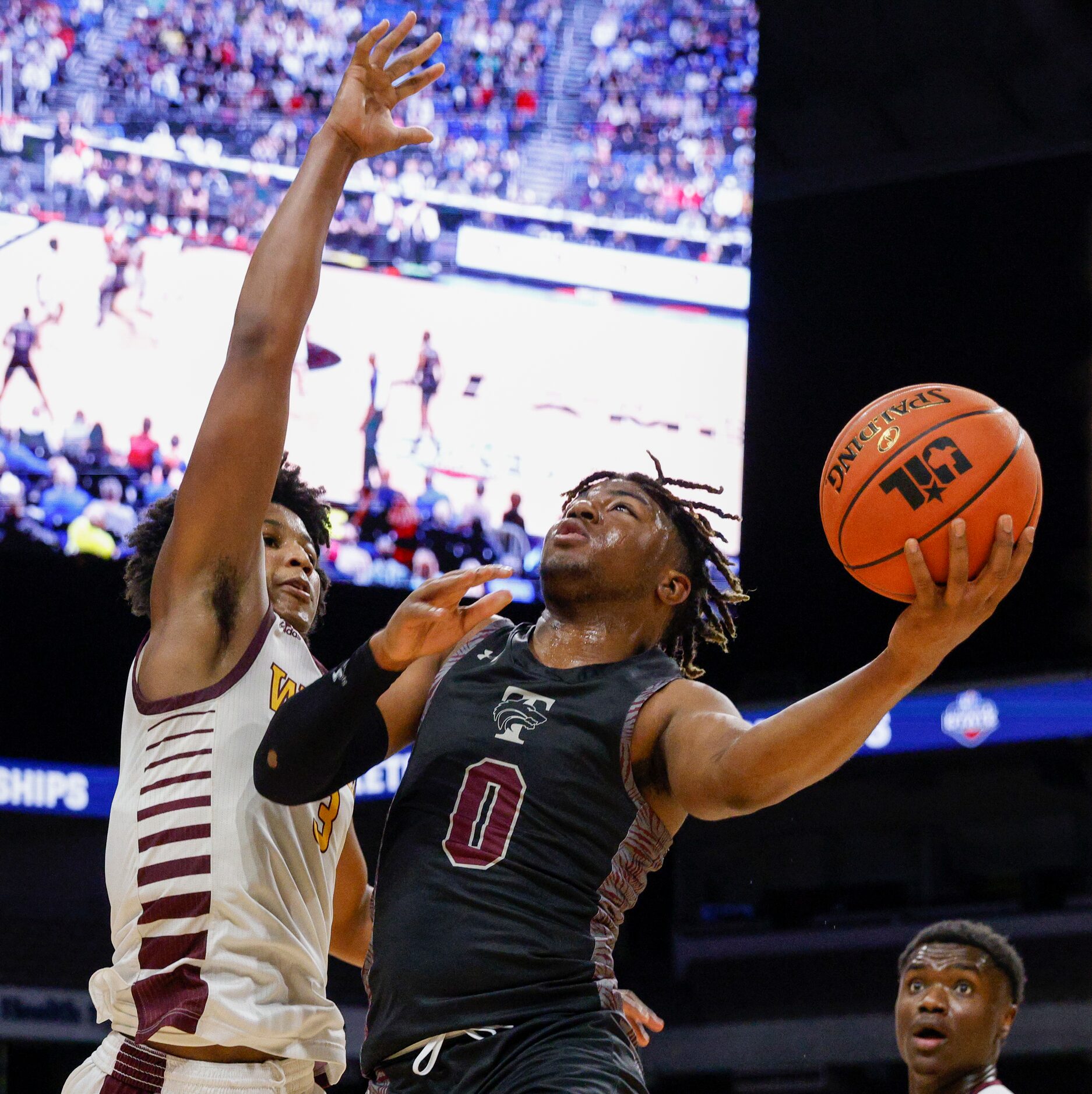 Mansfield Timberview guard Braylon Crosby (0) attempts a layup over Beaumont United guard...