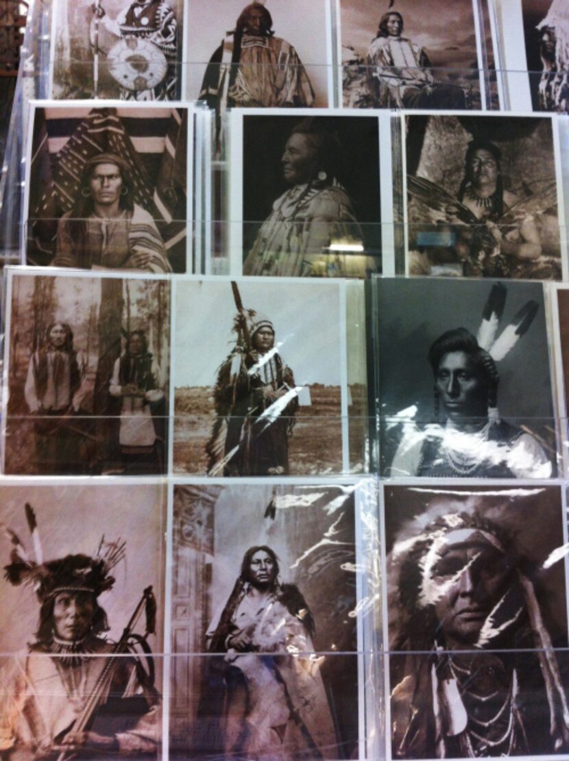 Black and white photographs of Native Americans line a wall at Antiques and Things in...