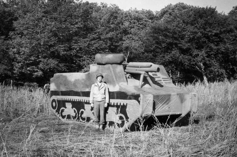 A soldier stands in front of an inflatable tank that he used as a member of the Ghost Army...