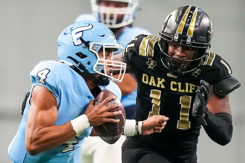 Frisco Emerson quarterback Michael Hawkins (4) scrambles away from South Oak Cliff...